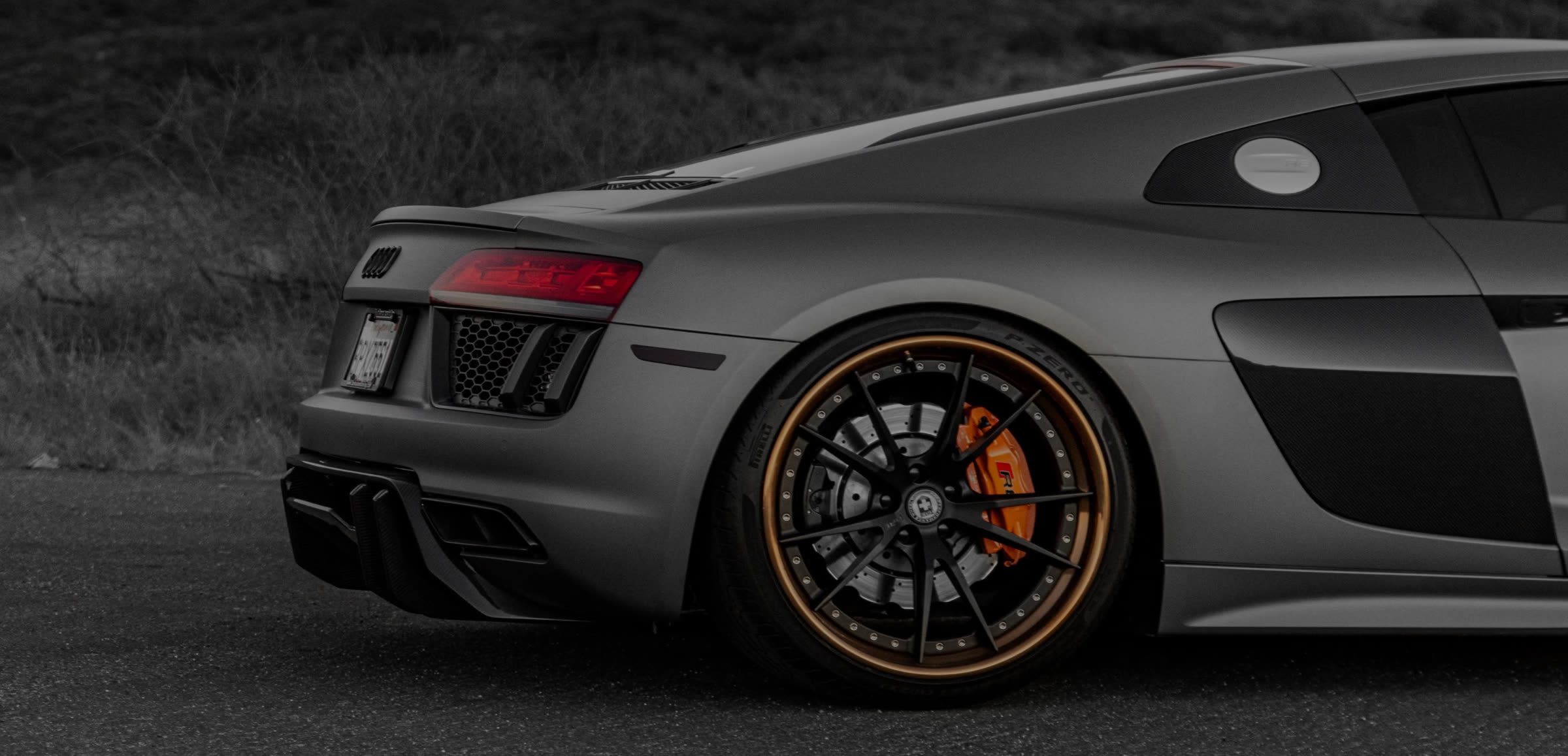 Audi R8 in matte grey paint, close-up of the rear wheel and rim