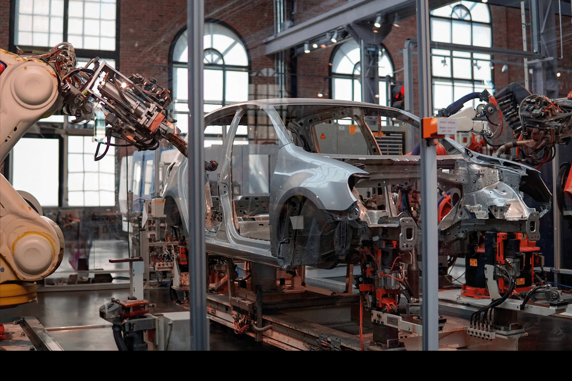 KUKA robots working on a car body in an assembly hall